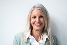 Smiling Senior Businesswoman Against White Background