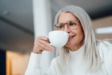 Smiling Senior Woman Drinking Coffee