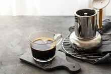 Freshly Brewed Coffee In Mug And Coffee Pot On Grey Background