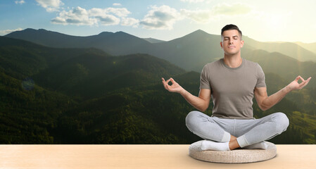 Sticker - Man practicing yoga on wooden surface against beautiful mountain landscape, space for text. Banner design