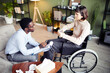 © Seventyfour - Young woman in wheelchair having private therapy session with psychologist to learn how to accept disability