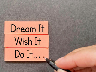 Wall Mural - Motivational and inspirational quote - dream it wish it do it text written on notepaper background. Stock photo.