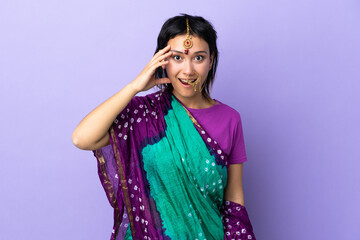 Wall Mural - Indian woman isolated on purple background has realized something and intending the solution