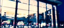 Blurred Background With Car Dealership Exterior. Abstract Blurred Photo Of Modern Building Motor Showroom. Blur Car Show Room Office Bokeh Lights. Automobile Retail Shop