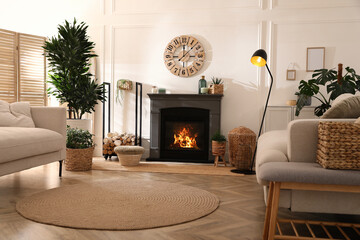 Wall Mural - Stylish living room interior with electric fireplace, comfortable sofas and beautiful decor elements