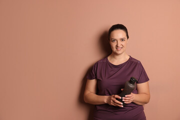 Sticker - Happy overweight woman with bottle of water on pale pink background, space for text