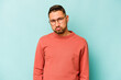 © Asier - Young hispanic man isolated on blue background sad, serious face, feeling miserable and displeased.