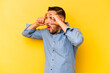 © Asier - Young hispanic man isolated on yellow background keeping eyes opened to find a success opportunity.