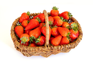 Wall Mural - ripe strawberry in a wicker basket on a white background