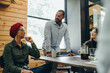 © Jacob Lund - Ethnic businesspeople having a meeting in a creative office