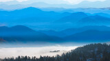 Fototapeta Niebo - Beautiful landscape with cascade blue mountains at the morning - View of wilderness mountains during foggy weather