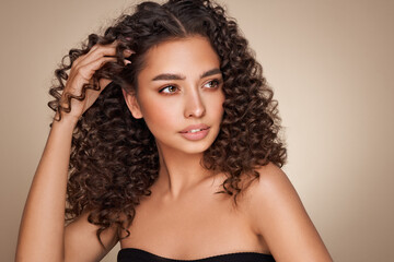 fashion studio portrait of beautiful smiling woman with afro curls hairstyle. fashion and beauty