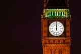 Fototapeta Big Ben - Big Ben of the Houses of Parliament London England UK at night striking midnight on new year's eve on Westminster Bridge which is a popular city landmark, stock photo with copy space