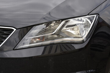 Wall Mural - Car's exterior details.Blue car - headlight on a black  car