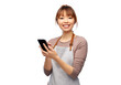 cooking, technology and people concept - happy smiling female chef or waitress in apron showing smartphone with empty screen over white background