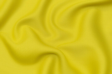 Wall Mural - Close-up texture of natural orange or yellow fabric or cloth in same color. Fabric texture of natural cotton, silk or wool, or linen textile material. Yellow canvas background.