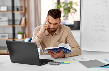 Poster - distant education, school and remote job concept - male math teacher with laptop computer, book and flip chart having online class or video call at home office