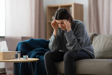 Mental Health, Psychological Problem And Depression Concept - Stressed Woman With Sedative Medicine Or Painkiller On Table Having Headache At Home