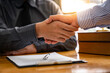 © crizzystudio - Lawyers shake hands with business people to seal a deal with partner lawyers. or a lawyer discussing contract agreements, handshake concepts, agreements, agreements