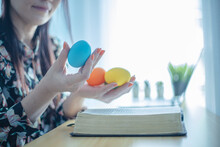 Hands Holding Colorful Easter Eggs, Christian Concept.
