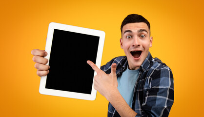 Poster - Excited hipster guy pointing at tablet with blank screen