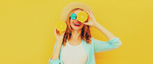 Summer Portrait Of Happy Smiling Young Woman With Slices Of Fresh Orange Fruits Wearing Straw Hat, Sunglasses On Yellow Background