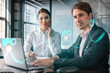 © VideoFlow - Businessman and businesswoman in formal wear working together to optimize IPO strategy at corporate fund. Financial chart hologram over office background with panoramic windows