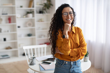 Wall Mural - Happy Middle Eastern Female Posing Smiling To Camera Standing Indoor