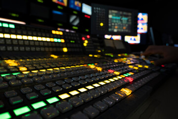 Wall Mural - TV editor working with vision mixer in television broadcast gallery