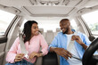 © Prostock-studio - Happy African American Couple Putting On Seatbelts