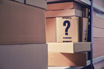 Question mark on a cardboard box, marking. Problems with labeling boxes in the warehouse and searching for parcels at the post office