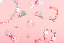 Children's Hair Accessories And Jewelry On A Pink Background. Little Girls Accessories, Flat Lay