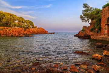Wall Mural - Red rocks beach, rocky coast at sunset in Southern France, French Riviera. Calm and tranquility.