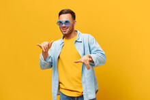 Overjoyed Tanned Handsome Man In Blue Shirt Trendy Sunglasses Dance Sing Posing Isolated On Orange Yellow Studio Background. Copy Space Banner Mockup. Relax Time Party Concept