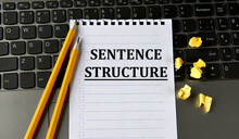 SENTENCE STRUCTURE - Words In A White Notepad On The Background Of A Laptop With Pencils