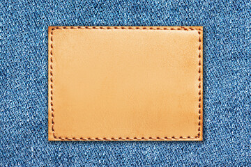 fashion background with empty copy space for graphic design. blank leather label tag. blue jeans den