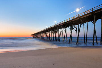 Wall Mural - Kure Beach Fishing Pier before sun rise, Kure Beach, North Carolina, USA. 