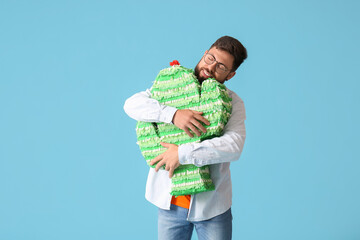 Poster - Handsome man with Mexican pinata on color background