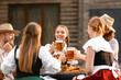 © Pixel-Shot - People with beer celebrating Octoberfest outdoors