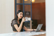 © PaeGAG - Portrait of Asian young female working on laptop and financial report at office.