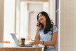 © PaeGAG - Asian woman in casual clothes is happy and cheerful while communicating with her smartphone and working in a coffee shop.