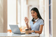 © PaeGAG - Asian woman having video call on her computer at home. Smiling girl studying online with teacher.