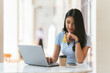 © PaeGAG - Online Banking Concept. Portrait Of Happy Young Asian Woman With Laptop And Credit Card Sitting in cafe, Smiling Asian Women Enjoying Making Payments From Home.