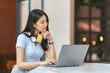 © PaeGAG - Online Banking Concept. Portrait Of Happy Young Asian Woman With Laptop And Credit Card Sitting in cafe, Smiling Asian Women Enjoying Making Payments From Home.