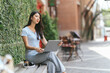 © PaeGAG - Portrait of beautiful Asian woman sitting outdoors at coffee shop restaurant during summer, using smart wireless technology computer laptop and smartphone, relaxing coffee break at cafe restaurant.
