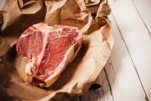 Raw T-Bone Steak On Paper