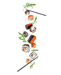 Various fresh sushi with arugula in the air isolated on a white background