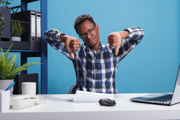 Wall Mural - dissatisfied african american agency manager making disapproval gesture because of unfit marketing s