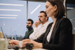 © Maskot - Dedicated businessman with male and female colleagues discussing in meeting at work place