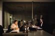 © Maskot - Multiracial female colleagues working late night at desk in office